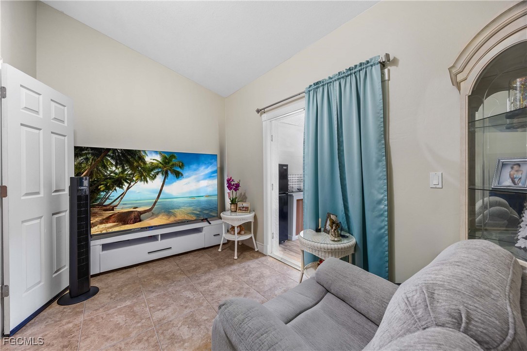 360 18th Street Northeast Naples, FL 34120 - Photo 27 of 37 a living room with furniture and a flat screen tv
