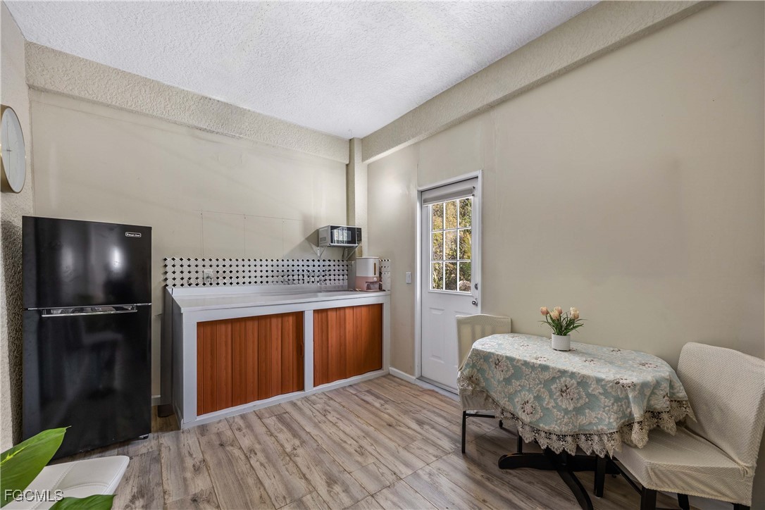 360 18th Street Northeast Naples, FL 34120 - Photo 28 of 37 a bedroom with a bed and a chandelier