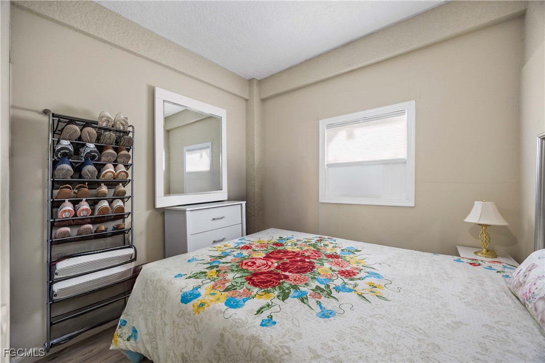 360 18th Street Northeast Naples, FL 34120 - Photo 29 of 37 a bedroom with a bed and a window