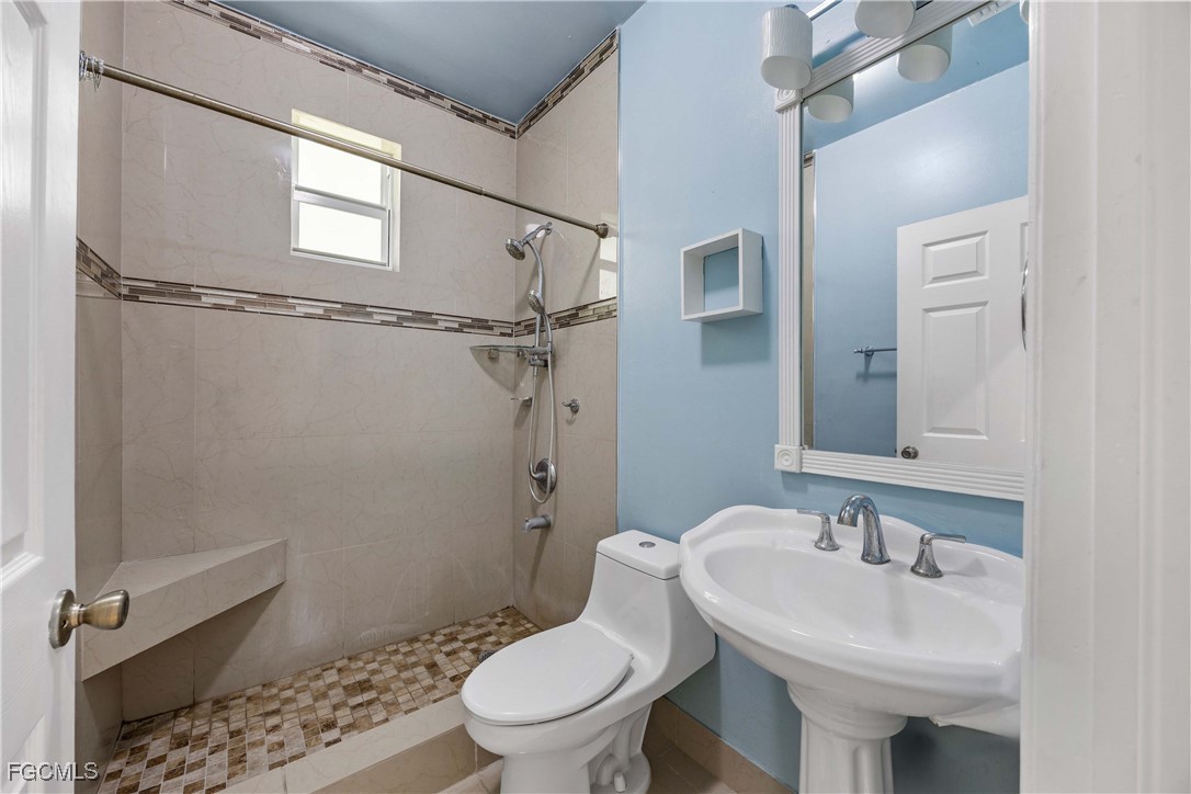 360 18th Street Northeast Naples, FL 34120 - Photo 32 of 37 a bathroom with a sink toilet and shower