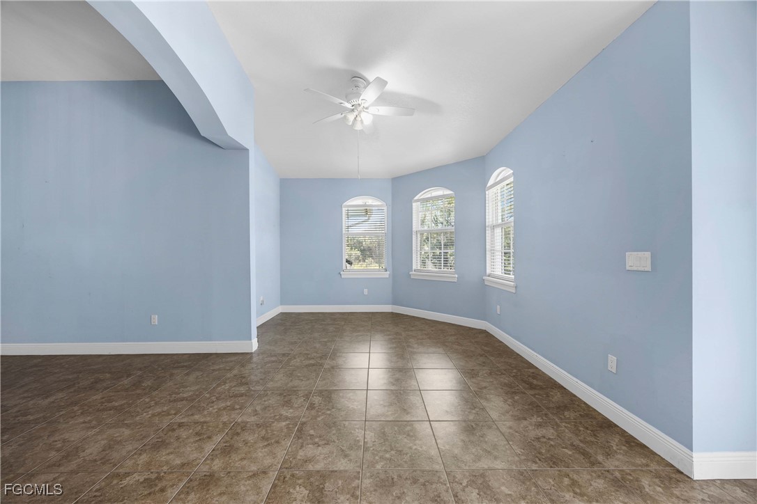 360 18th Street Northeast Naples, FL 34120 - Photo 10 of 37 an empty room with windows and ceiling fan