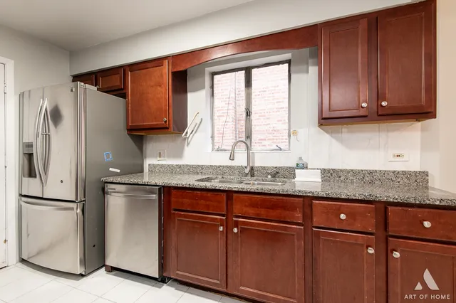 a kitchen with granite countertop wooden cabinets stainless steel appliances and a granite counter tops