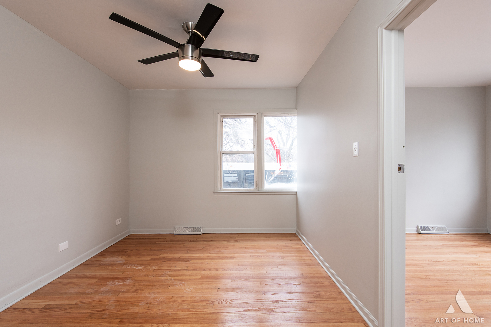 2750 North Linder Avenue, Unit 1 Chicago, IL 60639 - Photo 3 of 13 an empty room with wooden floor fan and windows