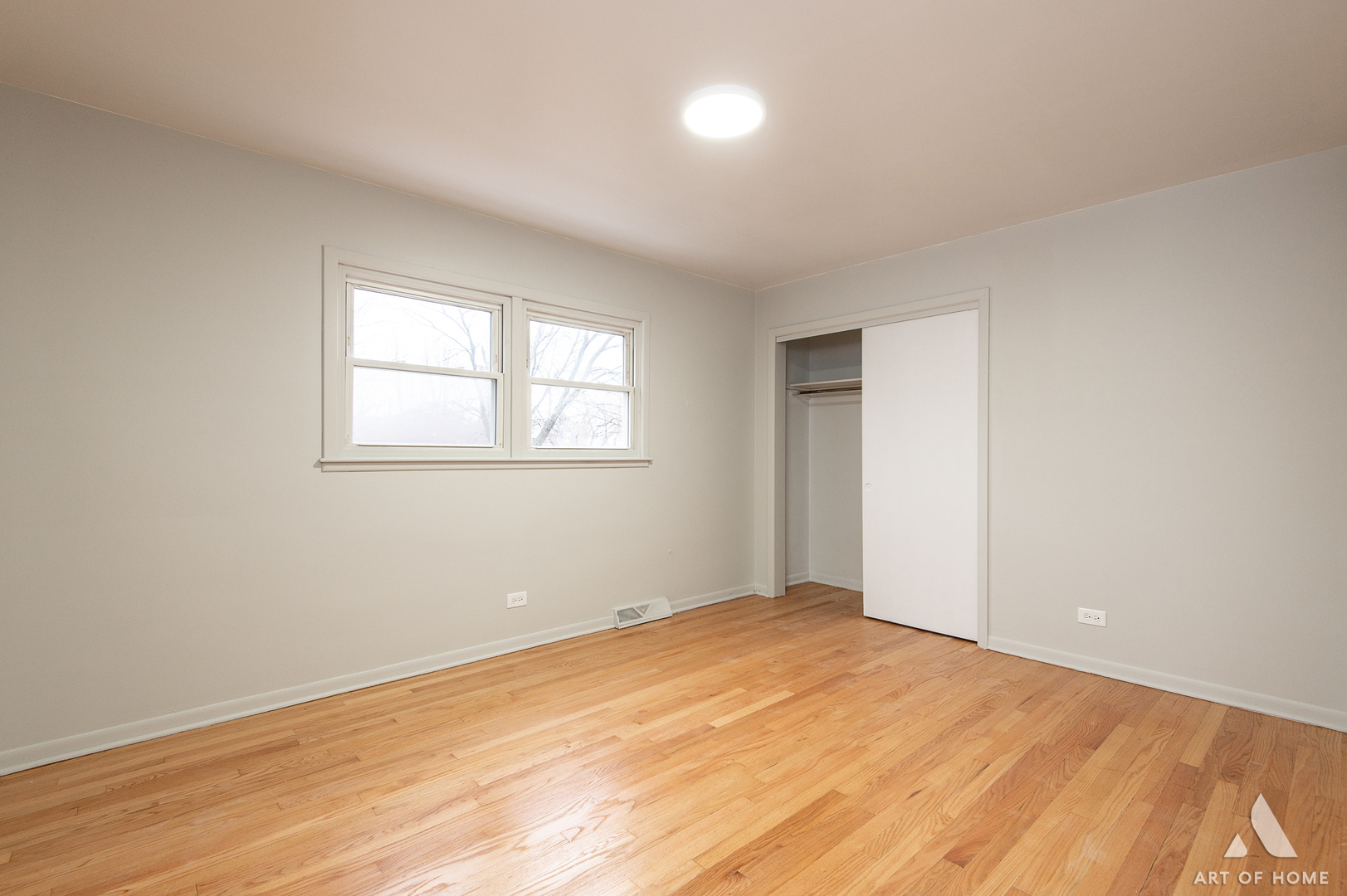 2750 North Linder Avenue, Unit 1 Chicago, IL 60639 - Photo 8 of 13 an empty room with wooden floor and windows