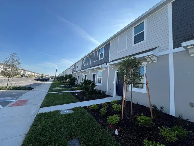 a view of a house with a yard and plants
