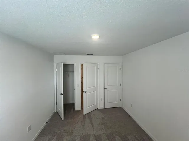 an empty room with closet area