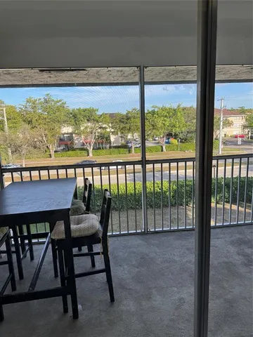 a view of a room with a ceiling fan