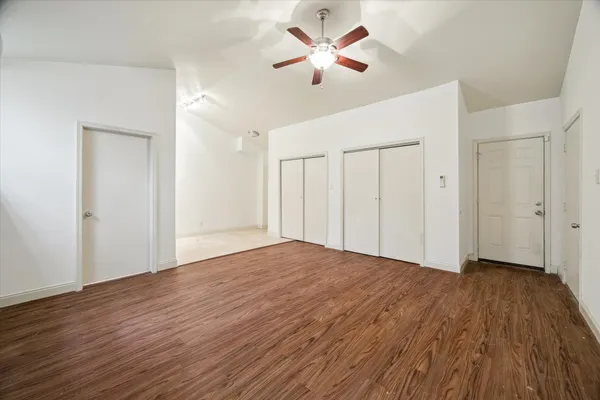 a view of empty room with wooden floor