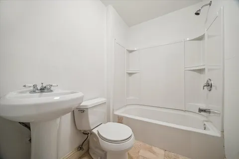 a bathroom with a sink toilet and bathtub