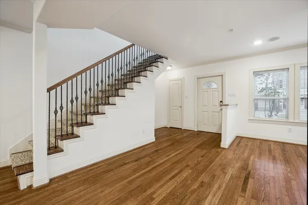 a view of an entryway with wooden floor