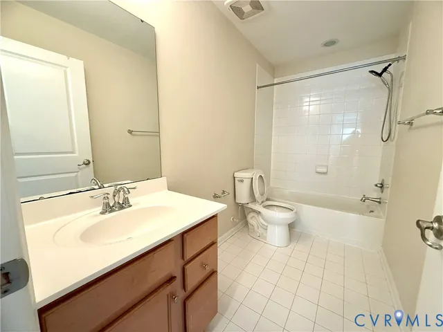 a bathroom with a sink mirror and a toilet