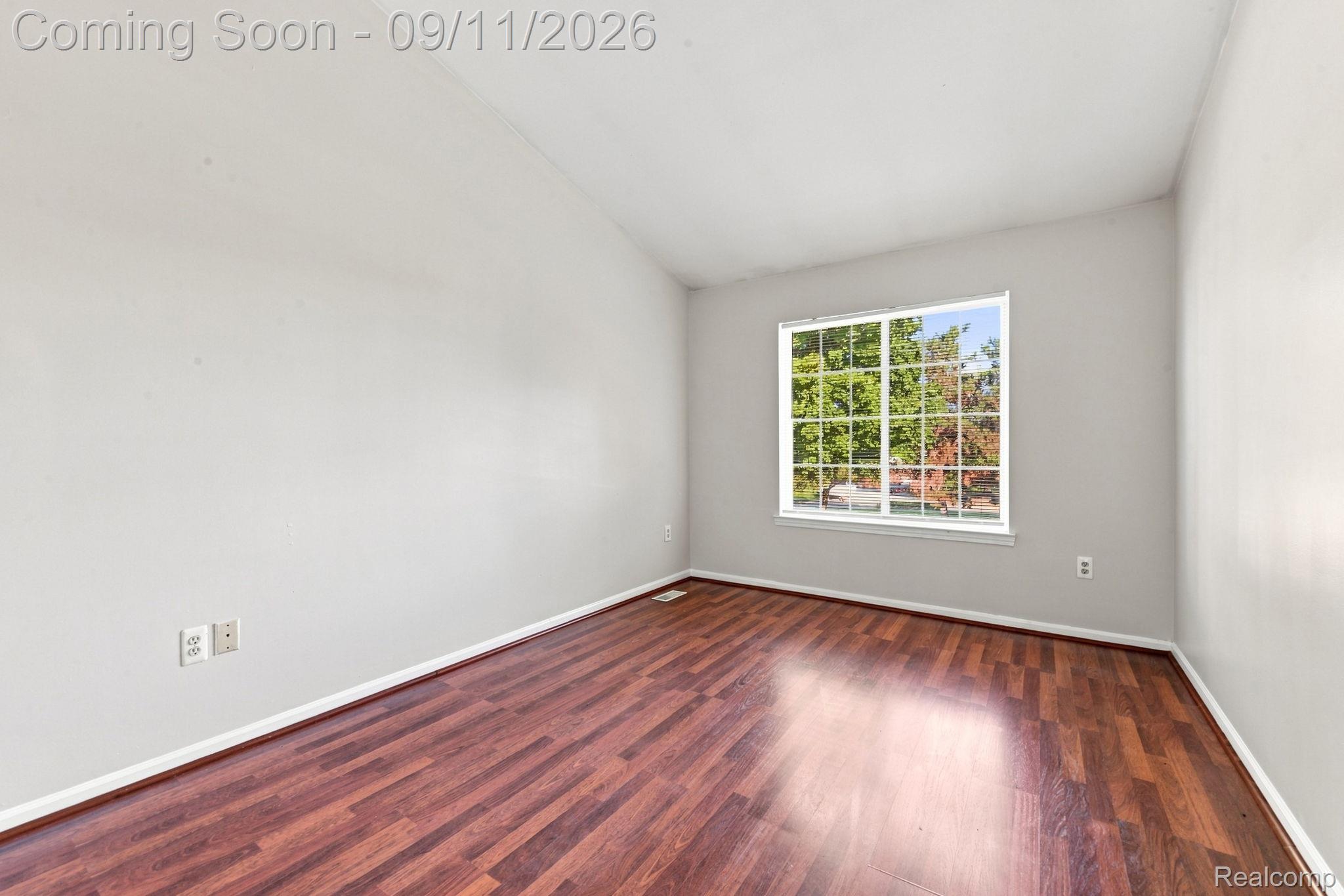3201 Lynhurst Court Rochester, MI 48306 - Photo 27 of 43 Wood-finish flooring, white trim, light gray walls, and a multi-pane window