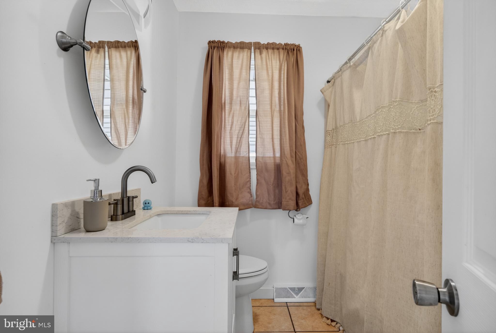 505 Monroe Street Riverside, NJ 08075 - Photo 11 of 35 a bathroom with a sink vanity and a mirror
