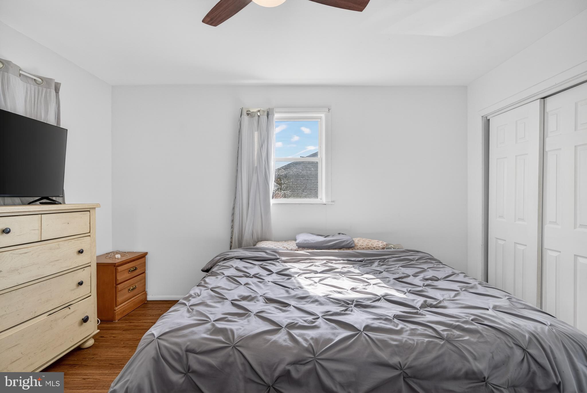 505 Monroe Street Riverside, NJ 08075 - Photo 13 of 35 a bedroom with a bed and a flat tv screen on the dresser