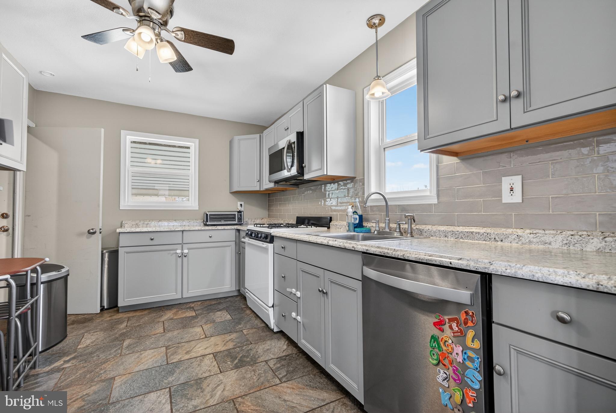 505 Monroe Street Riverside, NJ 08075 - Photo 7 of 35 a kitchen with stainless steel appliances granite countertop a sink stove and cabinets