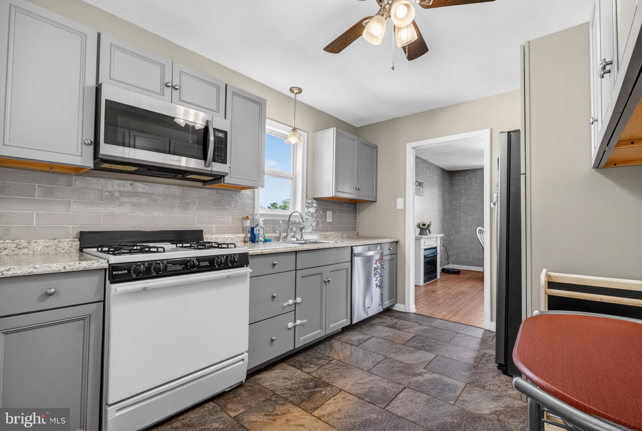 505 Monroe Street Riverside, NJ 08075 - Photo 8 of 35 a kitchen with stainless steel appliances a stove microwave and sink