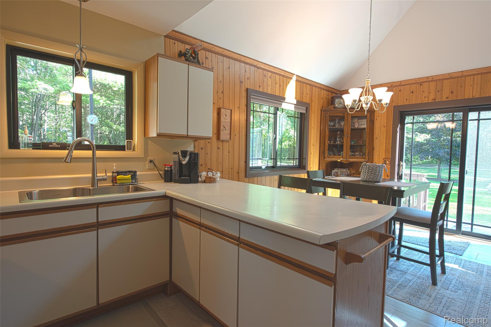 5799 Goodar Road South Branch, MI 48761 - Photo 14 of 58 Kitchen featuring white cabinetry with wood-finish trim, stainless steel sink appliances and light-toned countertops.