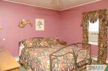138 Ridge Road Colonia, NJ 07067 - Photo 6 of 8 a bed room with a bed