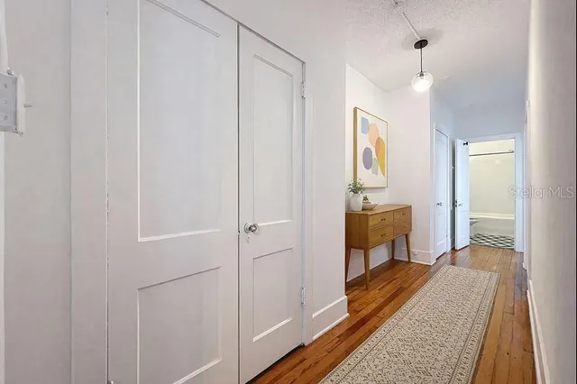 a spacious bedroom with a bed and a dresser