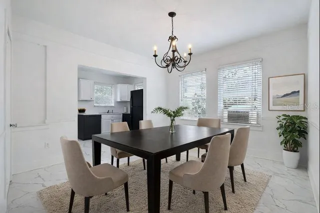 a kitchen with a refrigerator and a table