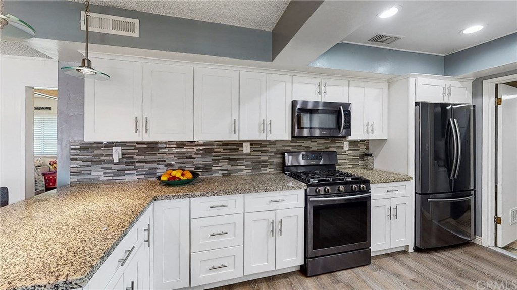 305 East Home Street Rialto, CA 92376 - Photo 1 of 1 Kitchen - facing fridge and stove