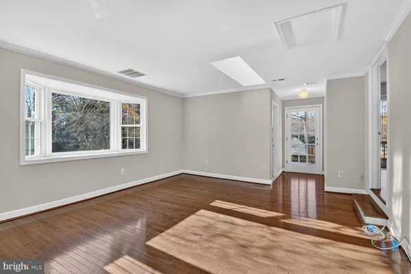 a view of a livingroom with wooden floor a fireplace and window