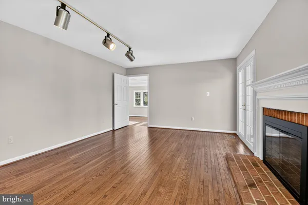 a view of a room with wooden floor and a fireplace