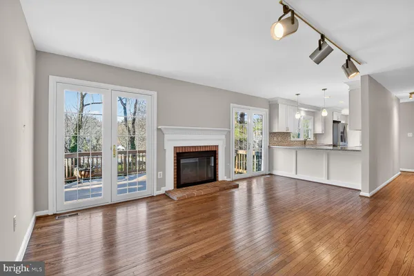 a kitchen with stainless steel appliances granite countertop a sink a stove and a wooden floors