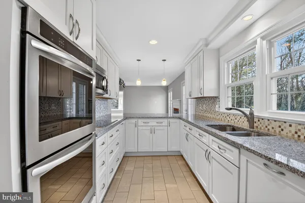 a kitchen with stainless steel appliances a refrigerator and a sink