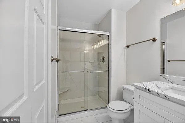 a view of an empty room and a ceiling fan