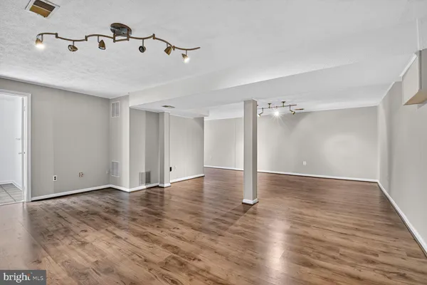 a view of a room with wooden floor