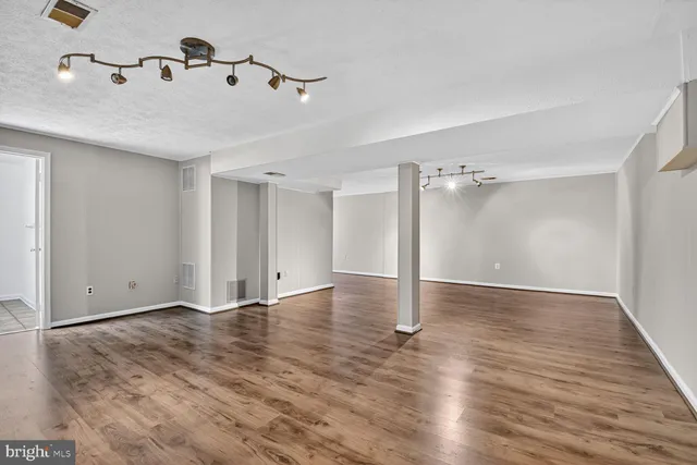a view of a room with wooden floor