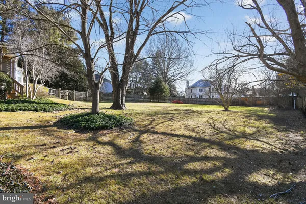 a view of a house with a yard covered with snow in the background