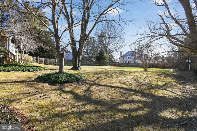 a view of a house with a yard covered with snow in the background