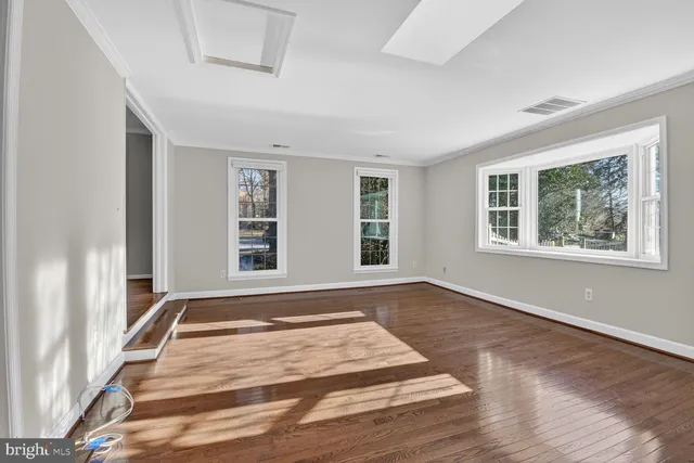a bedroom with wooden floor and a rug