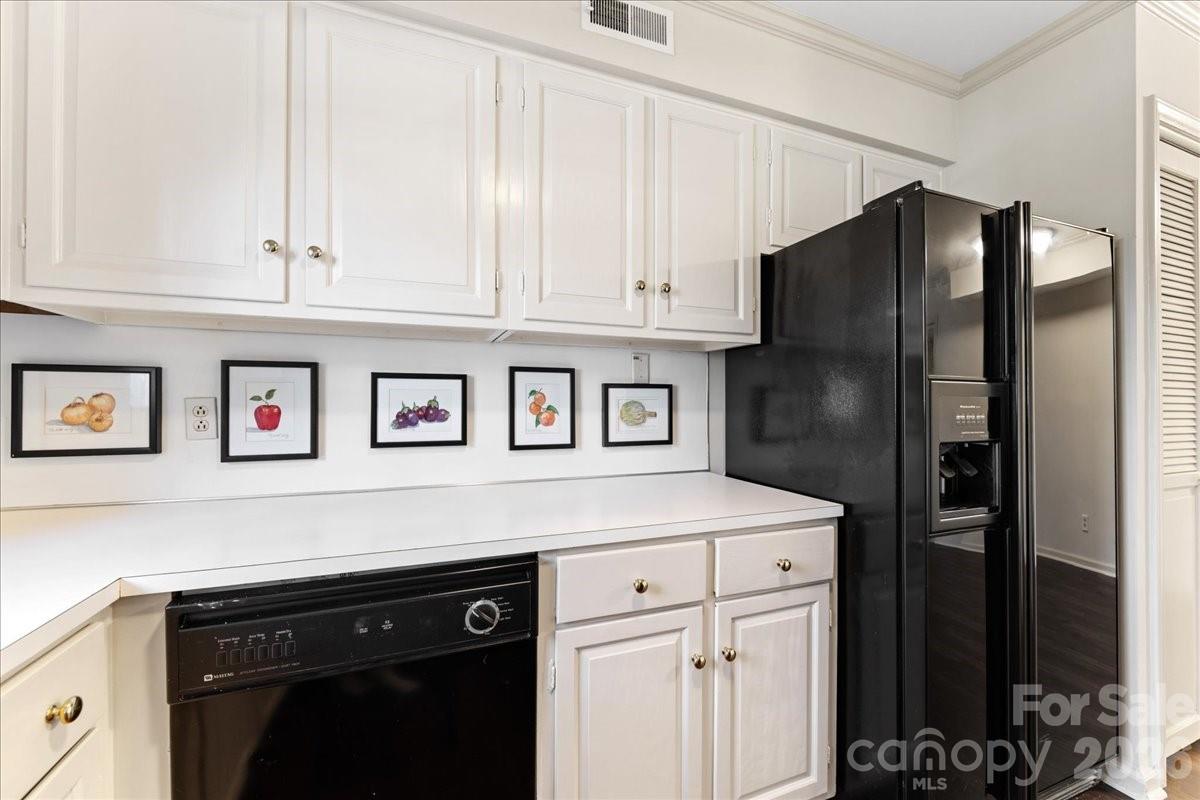 3500 Colony Road, Unit J Charlotte, NC 28211 - Photo 12 of 42 a kitchen with stainless steel appliances a refrigerator and cabinets