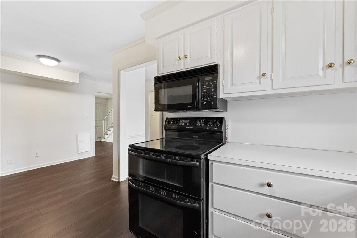3500 Colony Road, Unit J Charlotte, NC 28211 - Photo 13 of 42 a kitchen with granite countertop a stove and a microwave