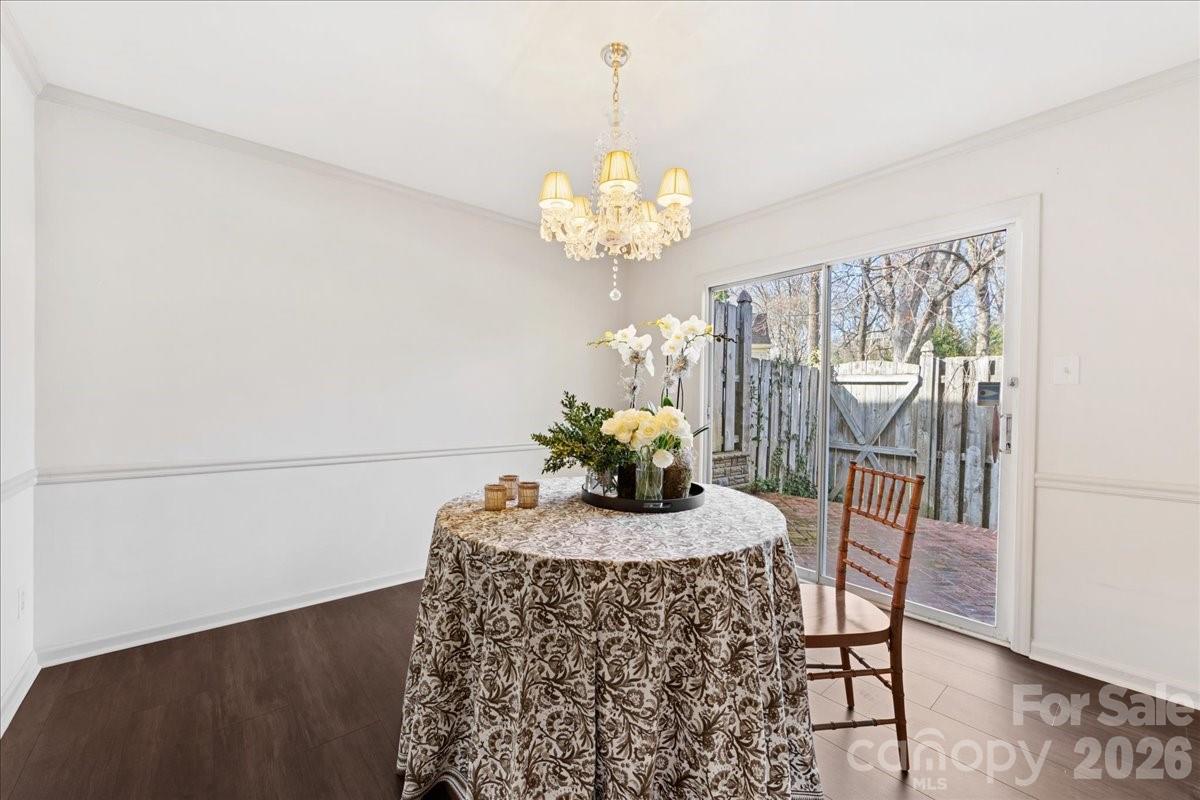3500 Colony Road, Unit J Charlotte, NC 28211 - Photo 17 of 42 a view of a dining room with furniture and chandelier