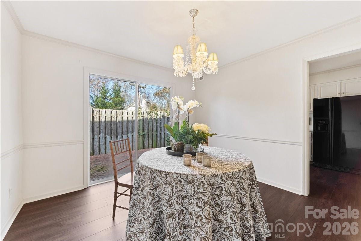 3500 Colony Road, Unit J Charlotte, NC 28211 - Photo 18 of 42 a dining room with furniture a chandelier and wooden floor