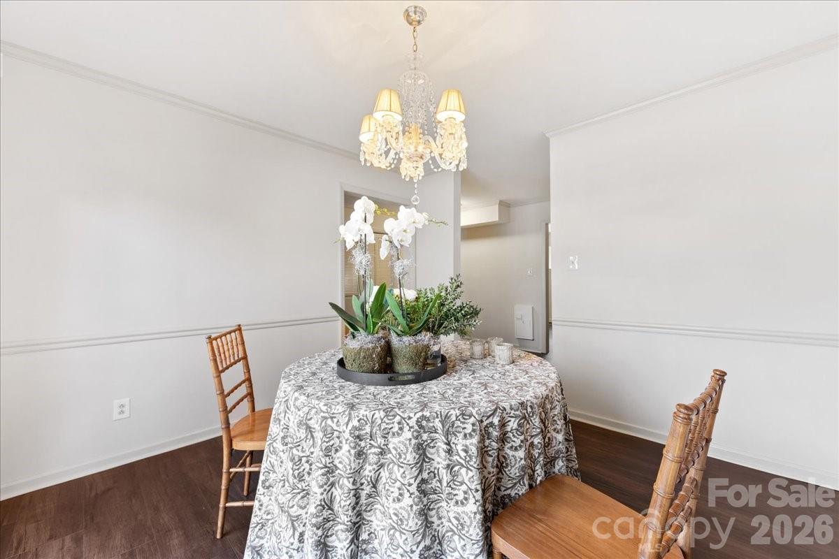 3500 Colony Road, Unit J Charlotte, NC 28211 - Photo 19 of 42 a view of a dining room with furniture and wooden floor
