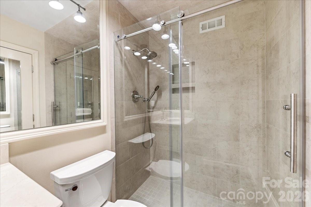 3500 Colony Road, Unit J Charlotte, NC 28211 - Photo 25 of 42 a bathroom with a shower a toilet and sink