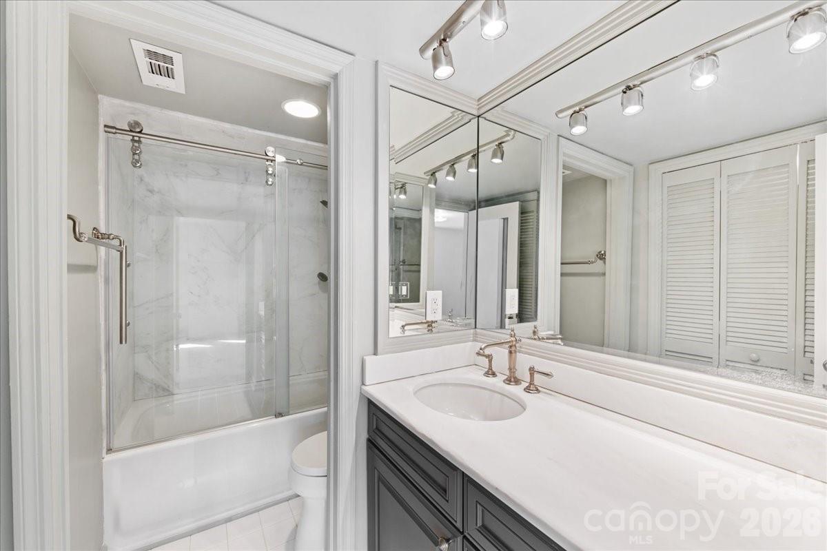3500 Colony Road, Unit J Charlotte, NC 28211 - Photo 32 of 42 a bathroom with a granite countertop sink mirror and shower