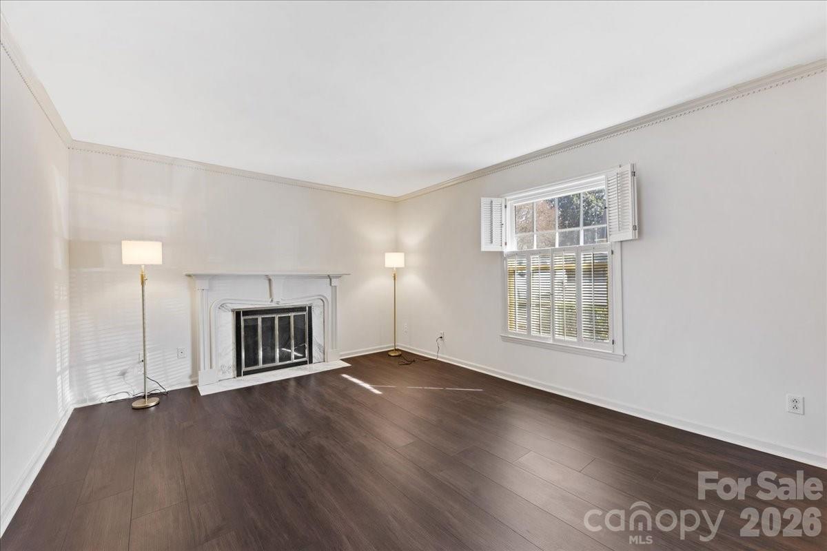 3500 Colony Road, Unit J Charlotte, NC 28211 - Photo 6 of 42 an empty room with wooden floor fireplace and windows