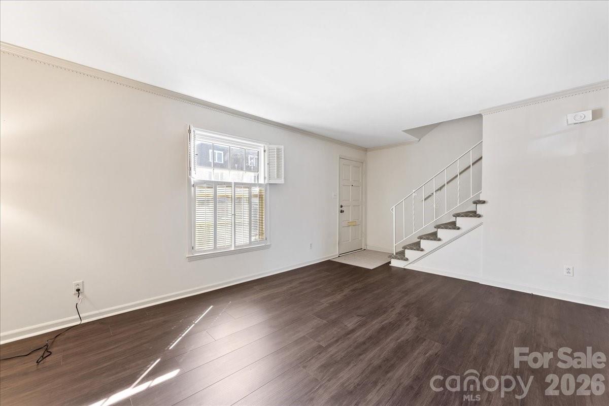 3500 Colony Road, Unit J Charlotte, NC 28211 - Photo 7 of 42 a view of an empty room with wooden floor and a window