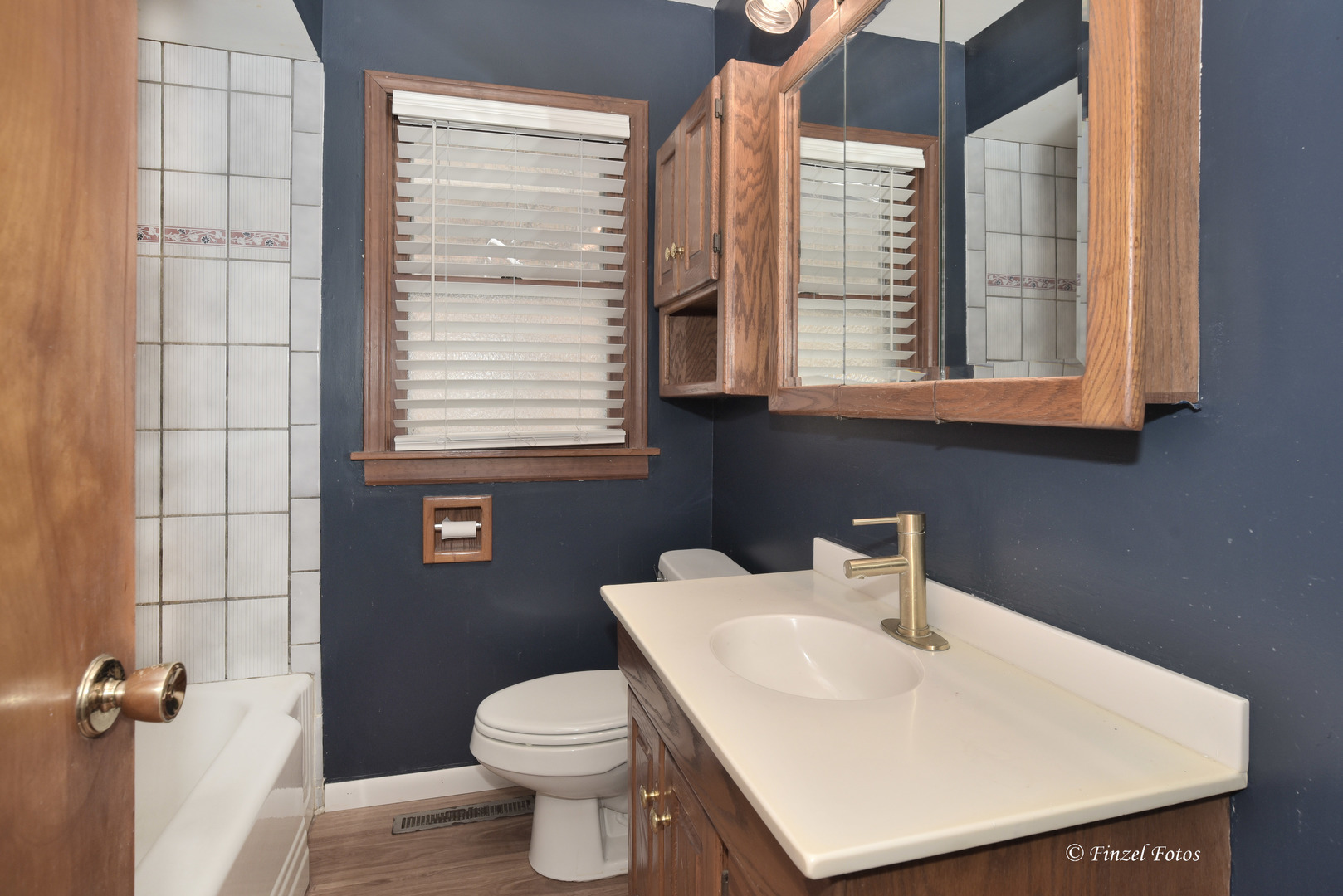 800 Morgan Street Elgin, IL 60123 - Photo 7 of 11 a bathroom with a sink a toilet and a window