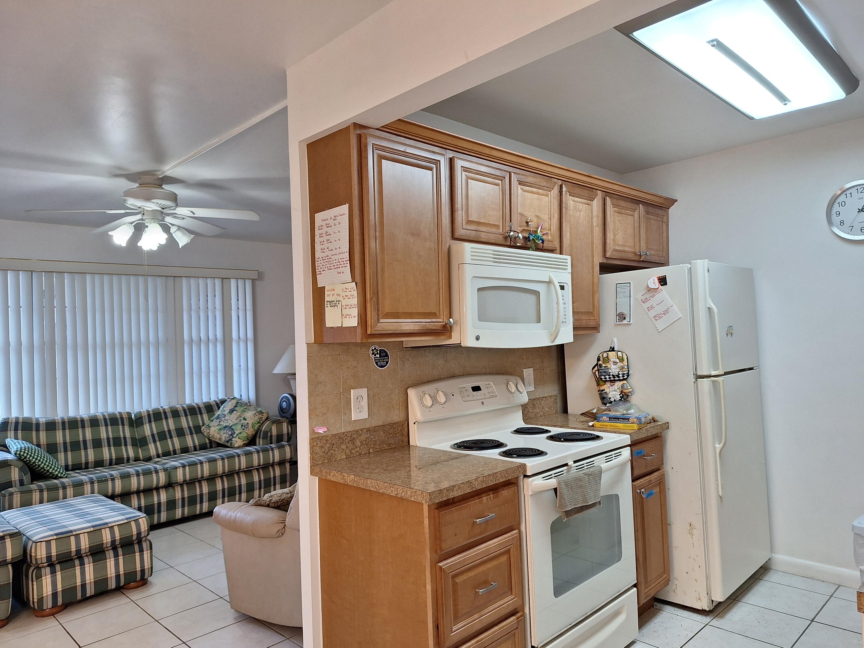 1010 Wolverton East Boca Raton, FL 33434 - Photo 5 of 30 a kitchen with stainless steel appliances granite countertop a sink stove and refrigerator