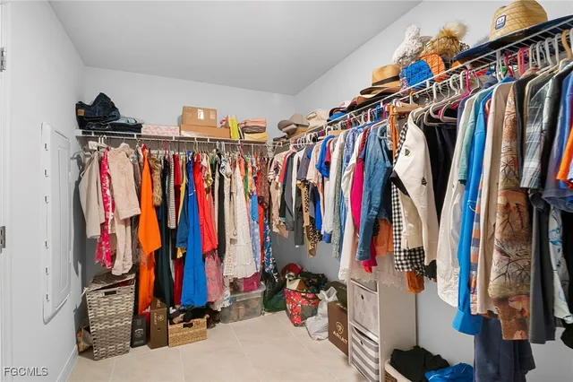 a view of walk in closet with clothes