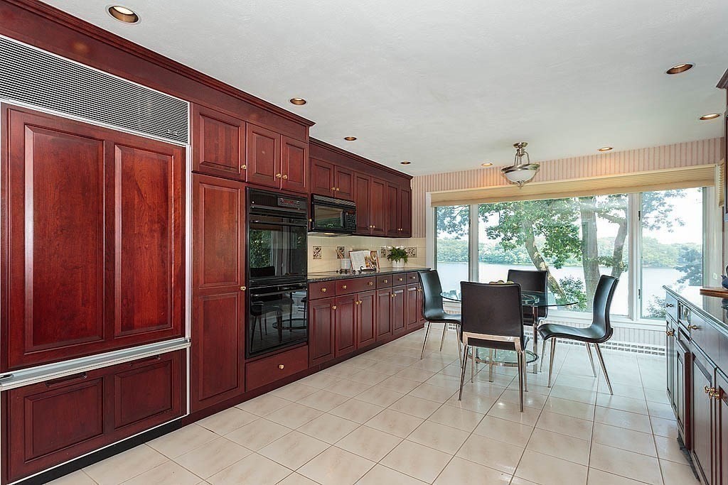39 Beverly Road Arlington, MA 02474 - Photo 12 of 37 a kitchen with a wooden table and chairs