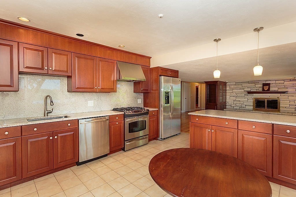39 Beverly Road Arlington, MA 02474 - Photo 15 of 37 a large kitchen with stainless steel appliances granite countertop a sink a stove and a refrigerator