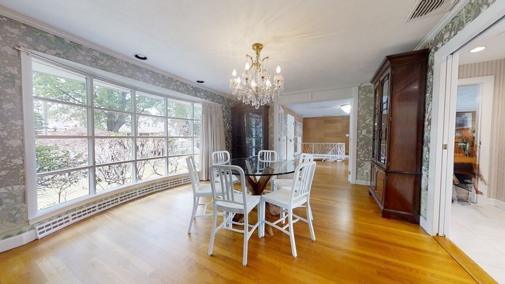 39 Beverly Road Arlington, MA 02474 - Photo 16 of 37 a view of a dining room with furniture a chandelier and wooden floor